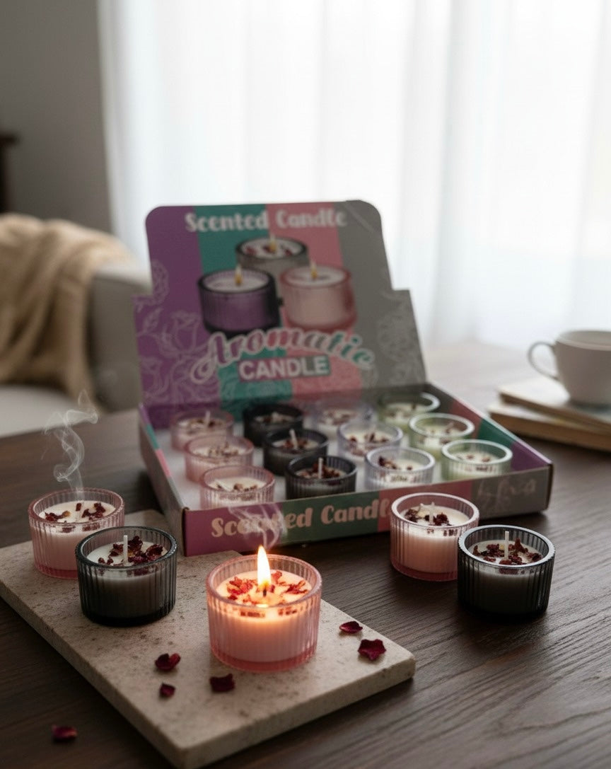 Scented candles with a display box on a table